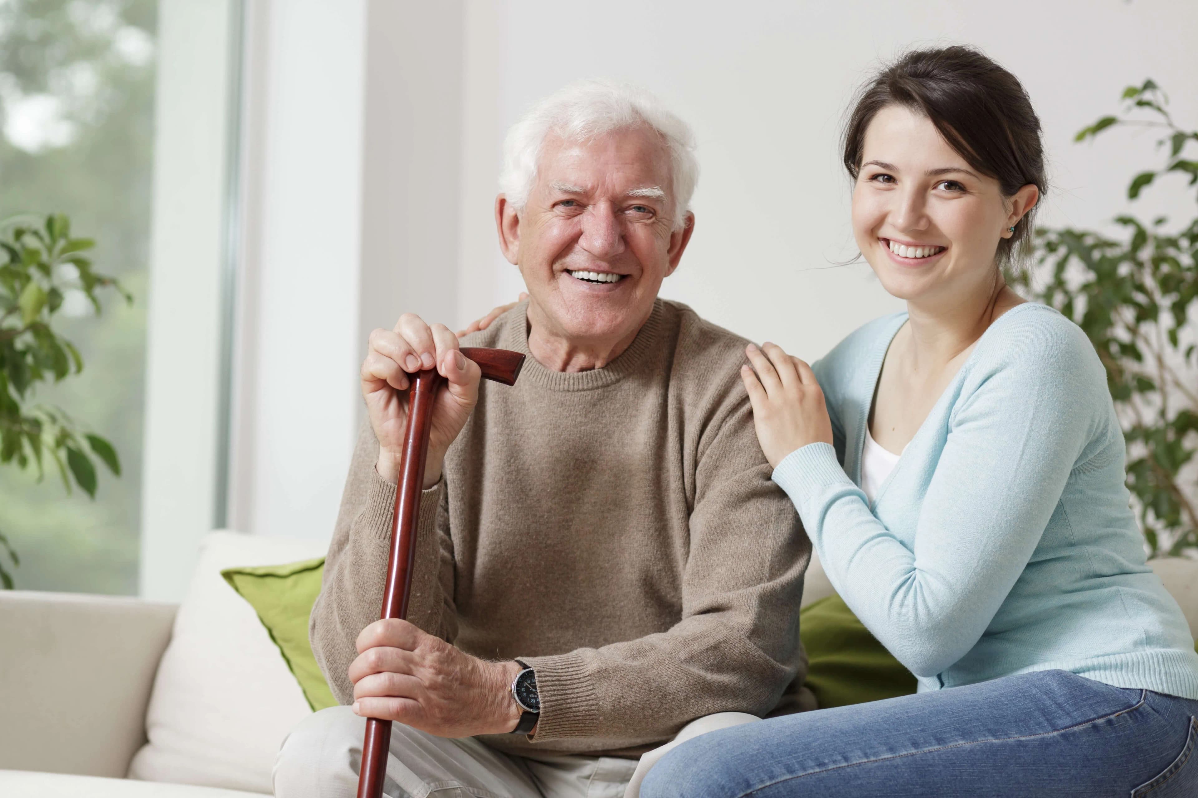 A young adult helping an elderly family member
